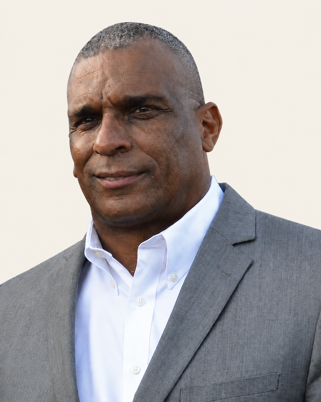 Jason Von Grimes in a gray suit and open white collar